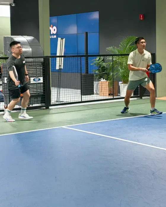 Two brioHR team members playing pickleball together